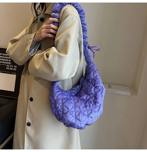 Detail of purple velvet quilted handbag with oversized scrunchie-style shoulder strap
