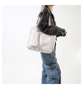 Detail of light purple nylon tote bag with front pockets and matching detachable pouch