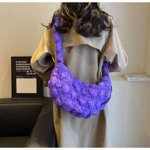 Detail of purple quilted hobo bag with bubble texture and wide shoulder strap