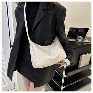 Minimalist beige PU leather hobo tote bag for women shown in a modern office setting