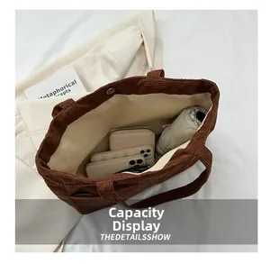 Detailed view of brown corduroy tote bag showing large capacity for wallet and umbrella