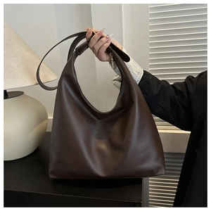 Detailed view of large dark brown PU leather tote bag with a minimalist matte finish