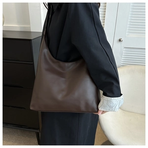 Detail view showing large capacity and soft leather texture of dark brown hobo shoulder bag