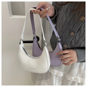Close-up of crescent-shaped PU leather shoulder bags in beige and lavender colors