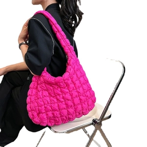 Quilted cloud shoulder bag in rose red featuring pleated texture and oversized crescent design