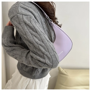 Purple crescent-shaped PU leather shoulder bag worn by model in casual chic style