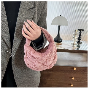 Detailed view of pink quilted hobo handbag featuring a soft plush texture and light nylon material