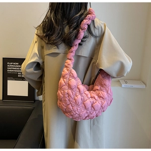 Pink quilted bubble fabric shoulder bag detail shown on model in a stylish trench coat