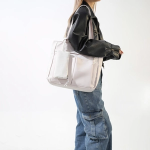 Minimalist light pink nylon tote bag with front pockets and small zipper pouch for women