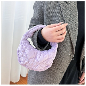 Detail of lavender quilted hobo bag with diamond pattern and plush padded texture