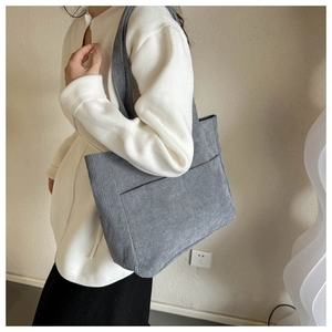 Gray corduroy tote bag worn by model, minimalist retro shoulder bag for daily use