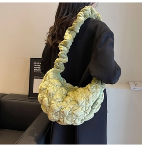 Close-up of a lime green quilted bubble hobo bag with a ruffled shoulder strap