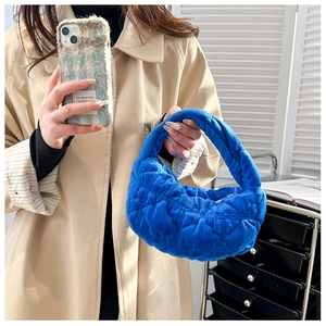 Blue quilted plush handbag with a minimalist puffy design for a trendy winter style