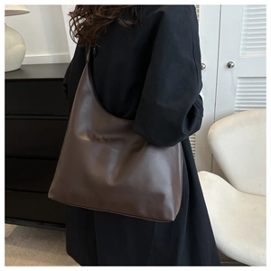 Elegant minimalist deep brown PU leather shoulder bag for women in a casual autumn setting