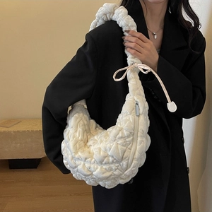 Minimalist white quilted cloud handbag with ruched strap and crescent shape for women