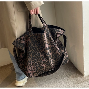Detailed close-up of high-capacity leopard print canvas tote bag with wide shoulder strap