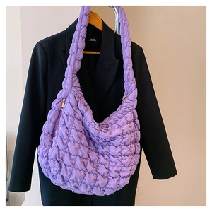 Detail view of purple quilted cloud bag with hobo silhouette and gold zipper closure