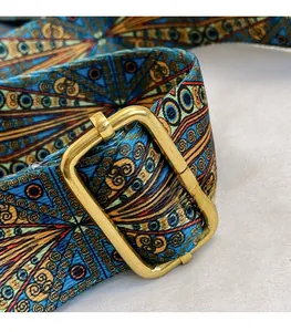 Close-up of ethnic style woven strap with premium gold square metal buckle on handbag