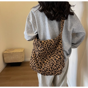 Rear view of a stylish leopard print fabric tote bag styled with a neutral winter outfit