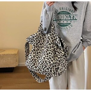 Close-up of leopard print canvas tote bag with adjustable shoulder strap and large capacity