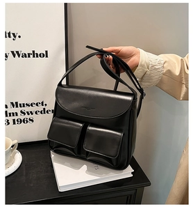 Detail of black PU leather shoulder bag with double pockets and FASHION & BAGS lettering