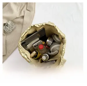 Spacious interior of golden tote bag showing compartments for tablet and essentials