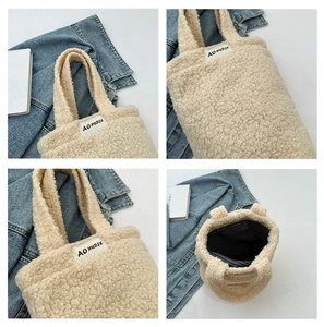 Detailed close-up of beige faux shearling handbag with black striped inner lining