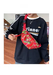 Detail of red crossbody bag with traditional peony pattern and adjustable strap