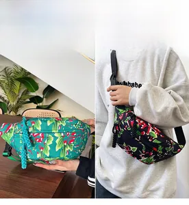 Floral print nylon crossbody waist bag in green and black with adjustable strap detail