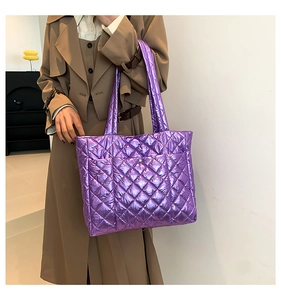 Macro shot of purple metallic quilted tote bag with diamond stitching texture
