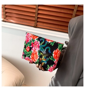 Detail of nylon clutch featuring traditional Chinese peony and phoenix embroidery patterns