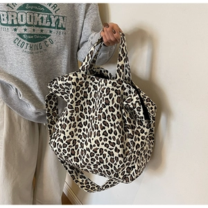 Brown leopard print canvas tote bag with dual handles and crossbody strap for women