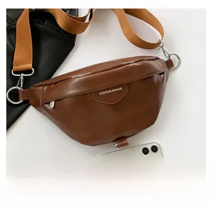Brown leather waist bag with adjustable strap and fashion text shown next to a smartphone