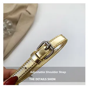 Detail of adjustable golden leather shoulder strap with polished silver metal buckle