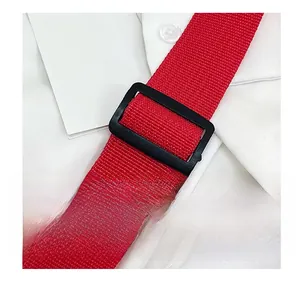 Close-up of red nylon shoulder strap with a black plastic adjustable buckle and buckle ring