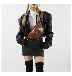 Close-up of brown PU leather shoulder bag featuring silver metal D-ring and wide strap