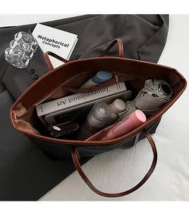 Detailed top view showing spacious nylon tote bag interior with a zipper pocket and contents