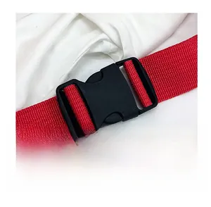 Detail shot of a red woven nylon shoulder strap with a black plastic quick release buckle