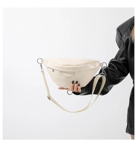 Detail of off-white PU leather fanny pack with silver hardware and adjustable strap