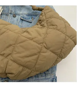 Close-up of khaki quilted puffer tote bag featuring soft diamond stitching texture