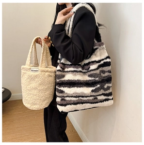 Close-up of plush bucket bag and zebra print tote showing soft fuzzy texture on model