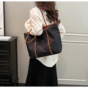 Detailed view of the large capacity nylon tote bag with contrasting brown PU straps