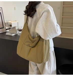 Quilted nylon hobo tote bag in khaki yellow with large front pocket for daily commute