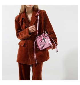 Pink metallic bucket bag with drawstring closure and silver cross charm detail