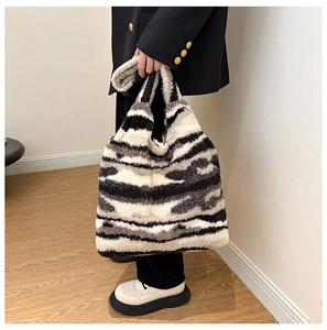 Chic winter plush tote bag with black and white abstract stripes and soft faux fur texture
