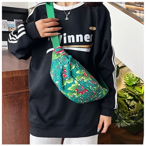 Close-up of winter green floral nylon crossbody bag with textured leaf pattern and zipper