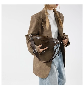 Detail view of the brown PU leather fanny pack showing texture and adjustable strap
