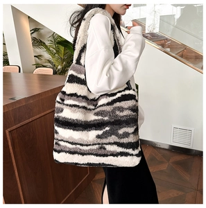 Detail showing the plush faux fur texture and zebra pattern on a large tote handbag