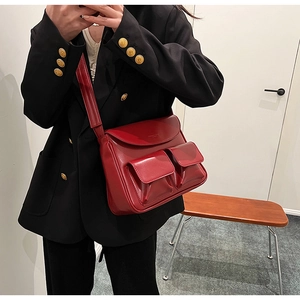 Classic deep red PU leather shoulder bag with dual front pockets for a retro winter style