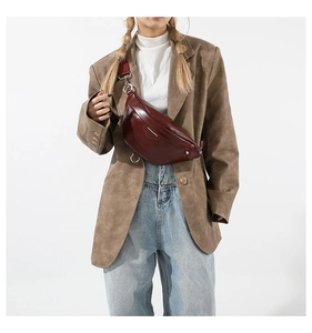 Detailed close-up of burgundy PU leather crossbody bag with wide strap and fashion print